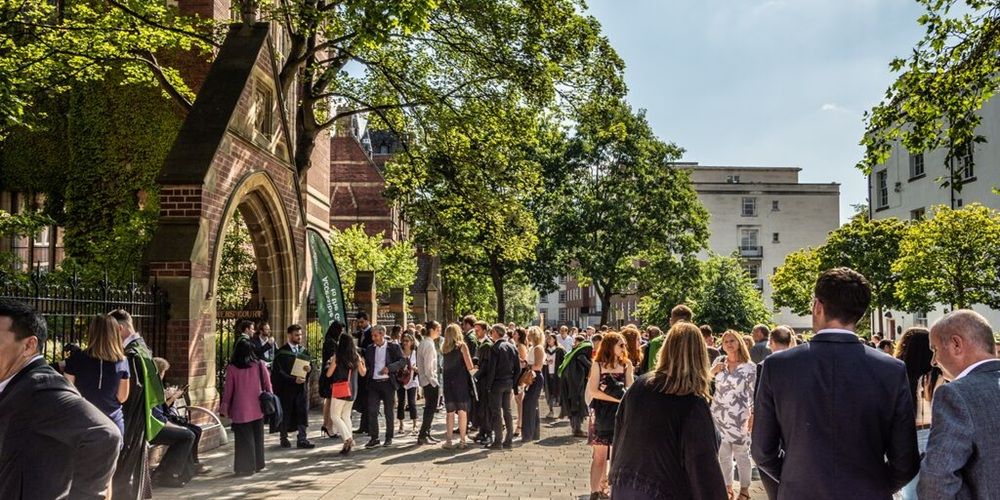 Students and their guests outside the Greay Hall on a sunny graduation day