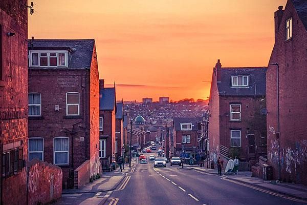 Sunset over a street in Hyde Park in Leeds.