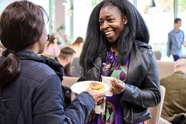 Two people talking enthusiastically at a networking event for Africa Week.