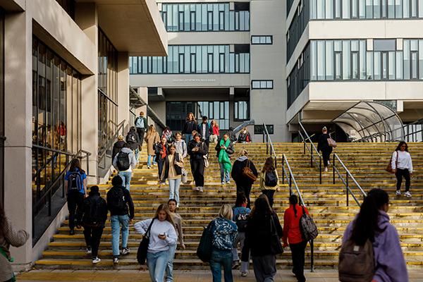 Student walking on steps on campus outside the Edward Boyle library