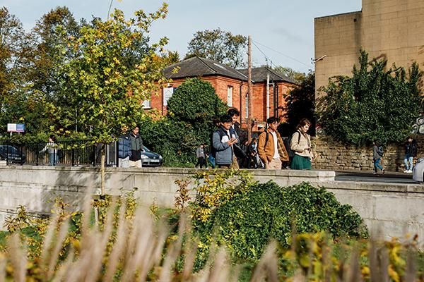 Students walking past the University on Woodhouse Lane